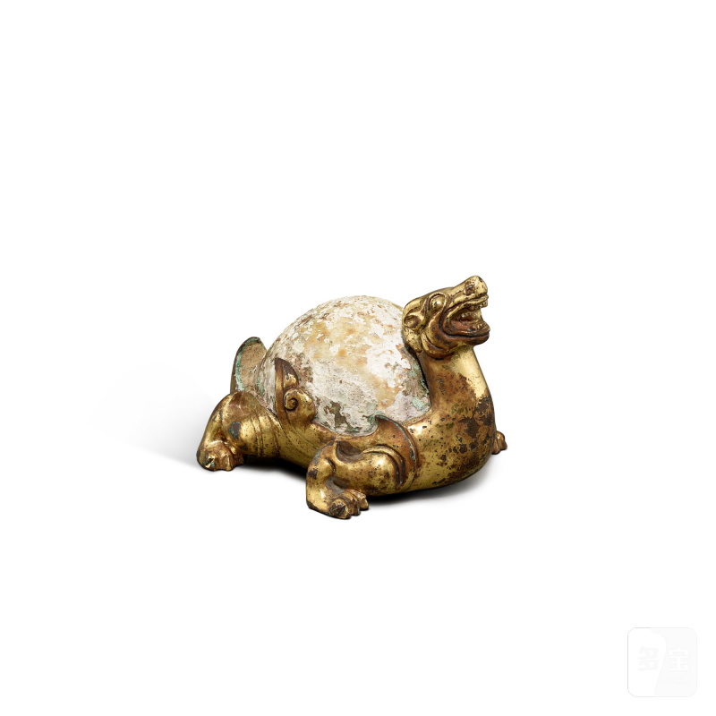 An archaic gilt-bronze and cowrie shell stag-form 'mythical beast' weight, Western Han dynasty | 西漢 銅鎏金嵌貝辟邪席鎮
